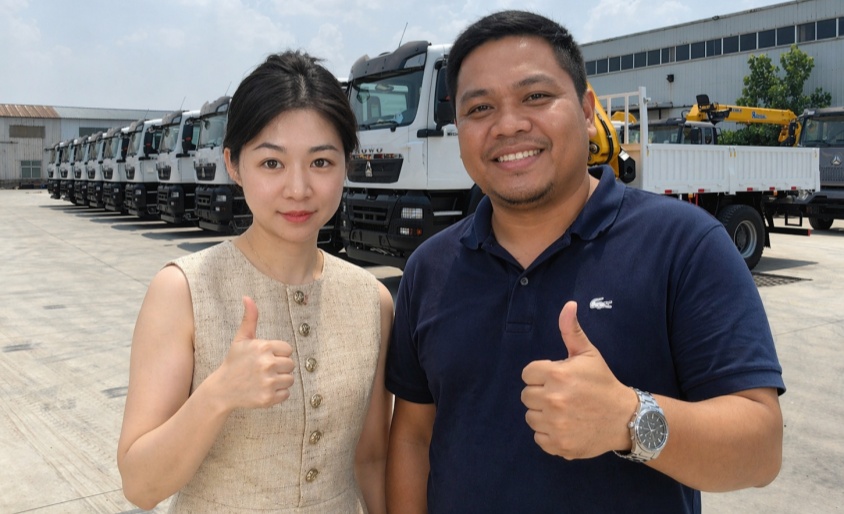 Thumbs Up! Happy Customer Orders HOWO 12-ton Crane Trucks After Satisfying Factory Tour